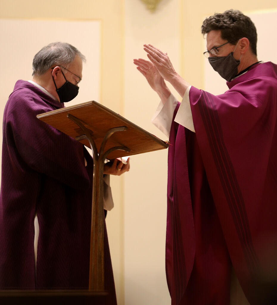 Deacon Bill Caubet and Fr. Francis Doyle prepare